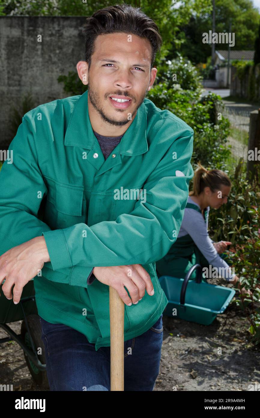 male gardener leaning on the handle of his tool Stock Photo - Alamy