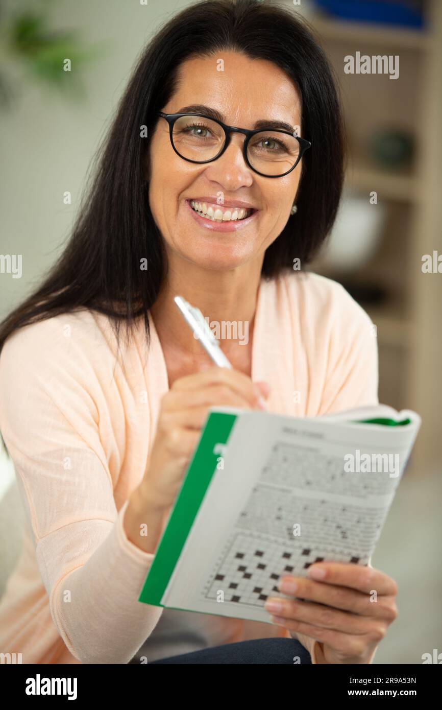 woman wearing glasses working on a crossword puzzle Stock Photo Alamy woman wearing glasses working on a crossword puzzle Stock Photo Alamy