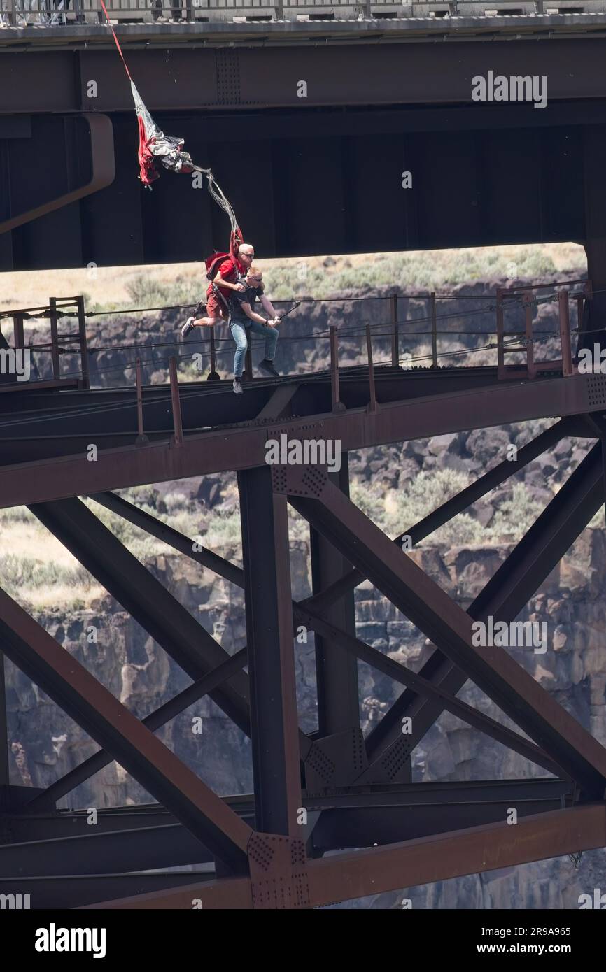Two people do a tandem base jump off of the Perrine Bridge in Twin