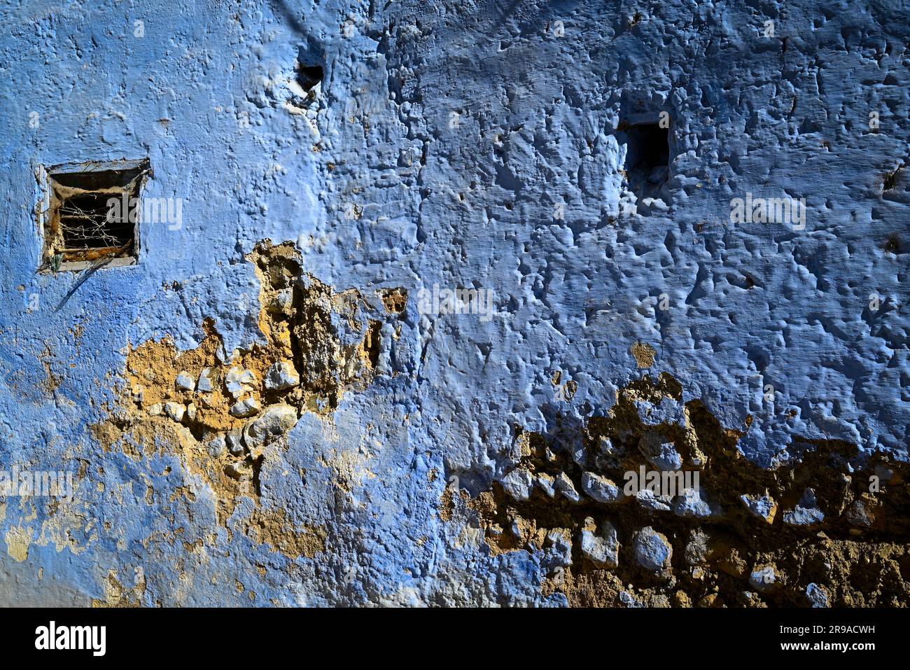 An ancient wall, deteriorating, but revived with 'blue  city' paint in Chefchaouen, Morocco Stock Photo