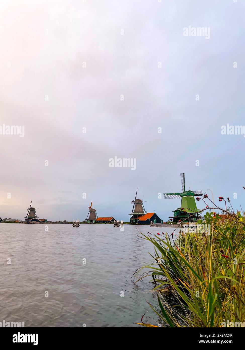 Zaanse Schans is a neighbourhood of Zaandam, near Zaandijk, Netherlands, famous for its collection of well-preserved historic windmills and houses. Stock Photo