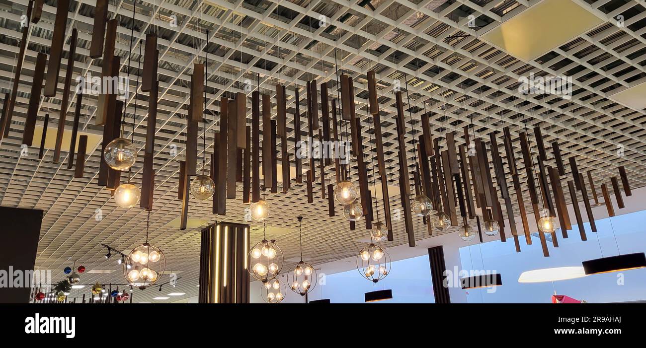 Hanging lamps adorn the ceiling. The interior of the room is decorated with ceiling lights. Stock Photo