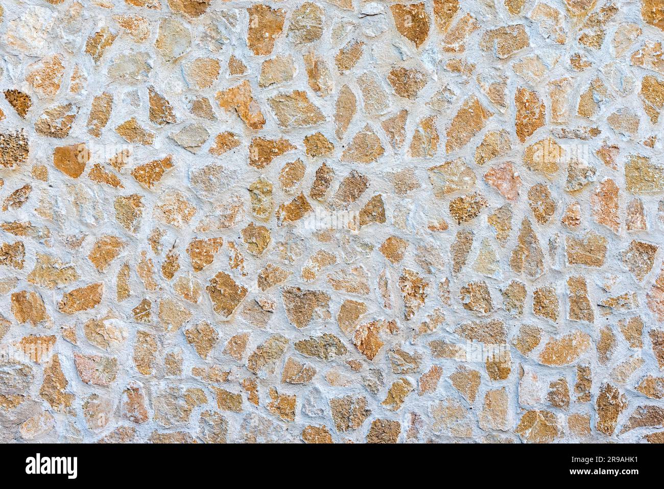 Background from a beige, old natural stone wall Stock Photo