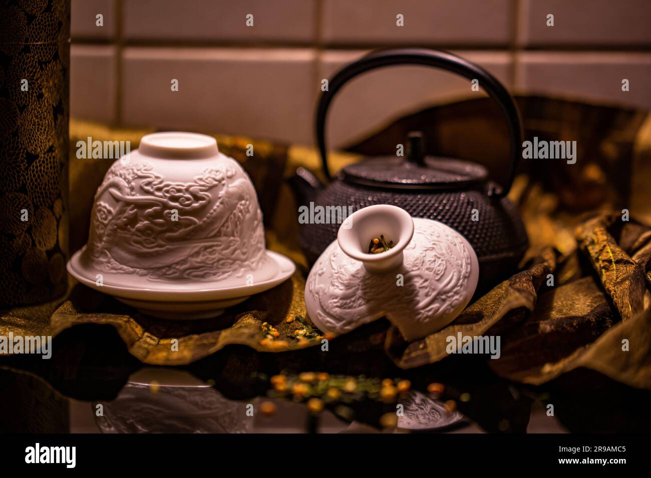 A vintage iron teapot is displayed alongside two ceramic mugs, creating a cozy and inviting atmosphere Stock Photo