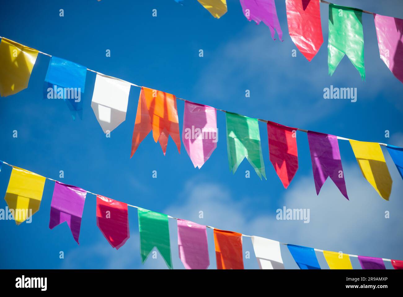 Colorful Flag Ropes Flags of different colors hanging from a rope. Decoration of Sao Joao ...