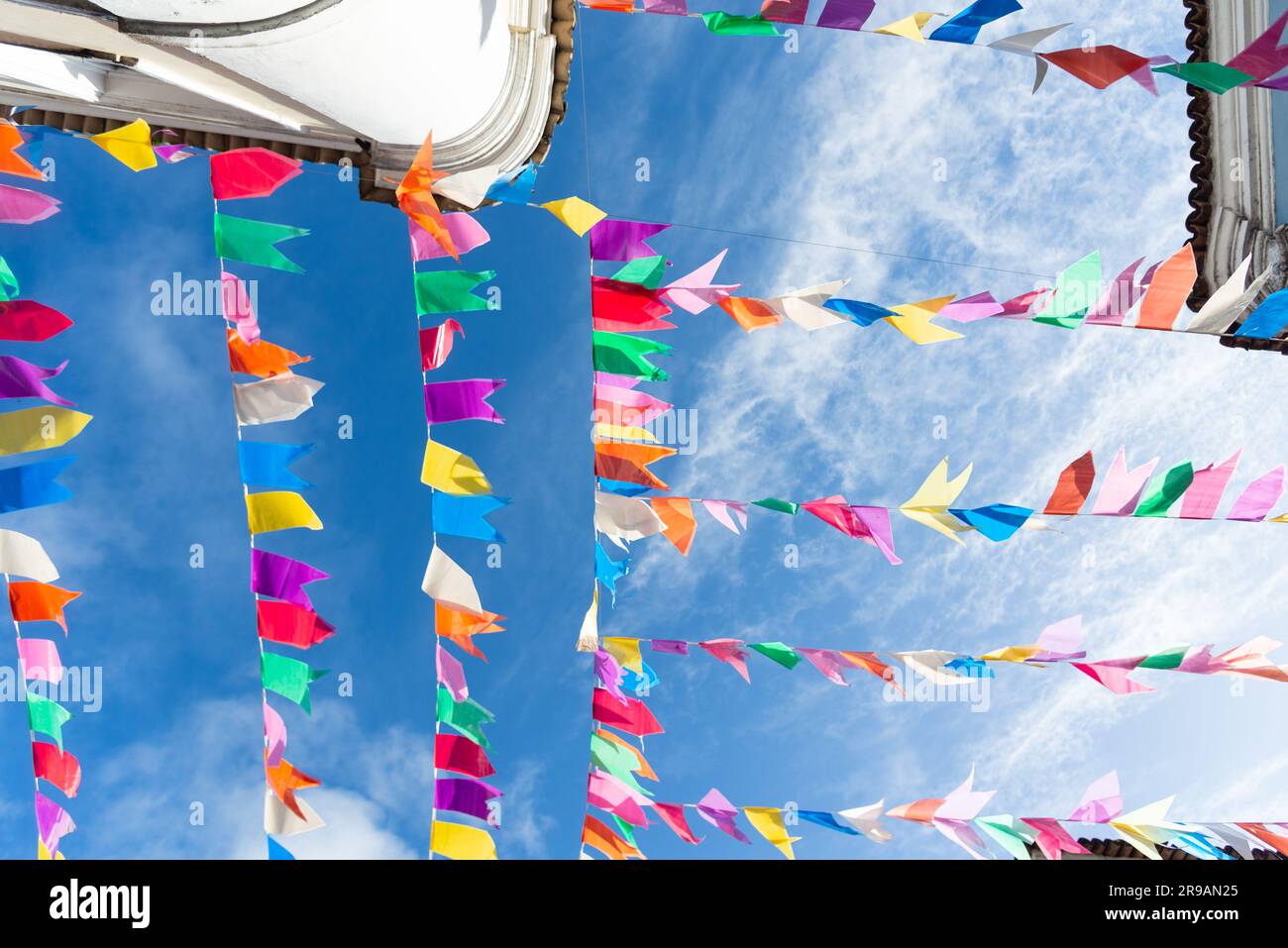 Colorful Flag Ropes Flags of different colors hanging from a rope. Decoration of Sao Joao ...