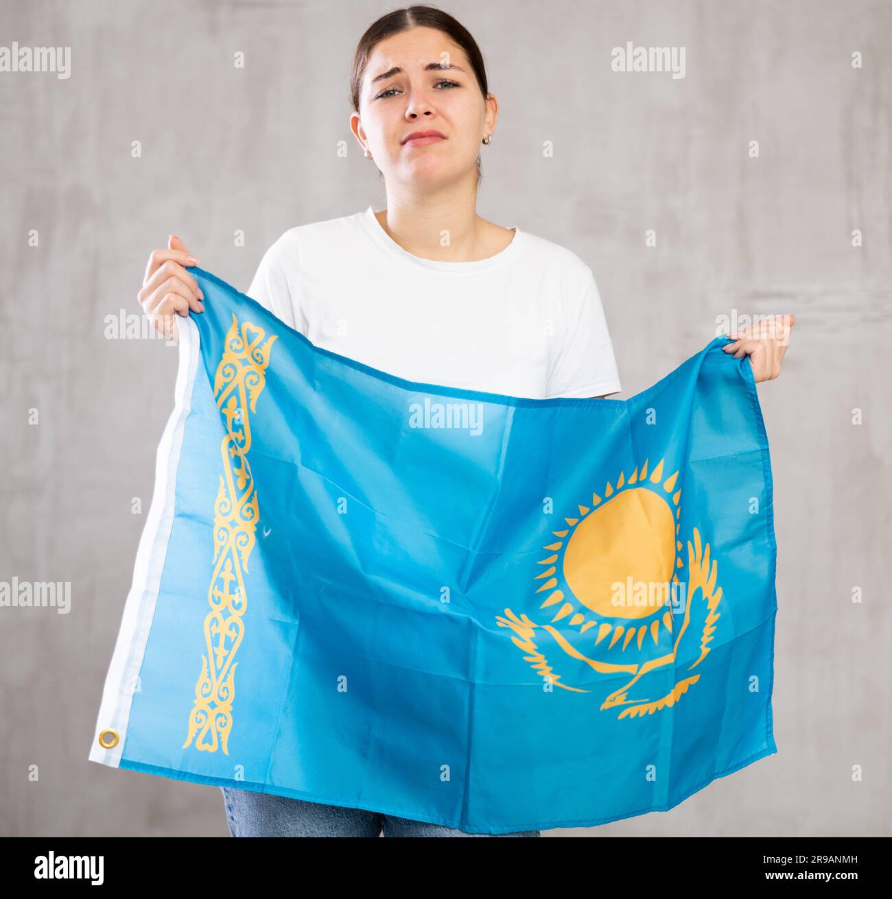 Sad young woman holding flag of Kazakhstan Stock Photo - Alamy