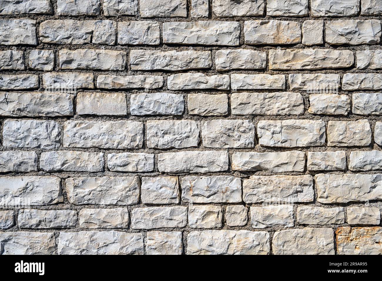 Background from a uniform natural stone wall Stock Photo