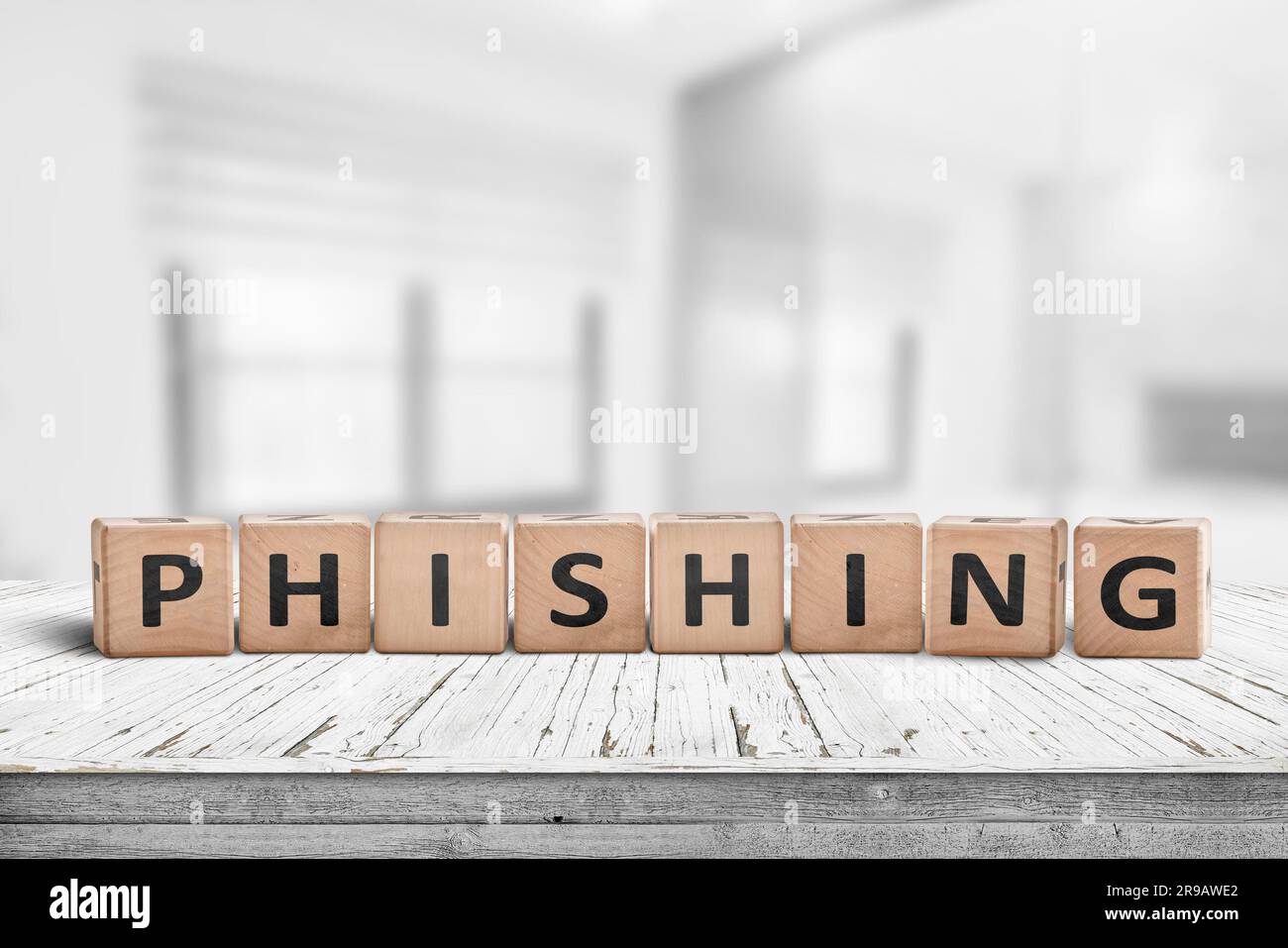 Phishing scam sign on a wooden table in a bright office with blocks Stock Photo