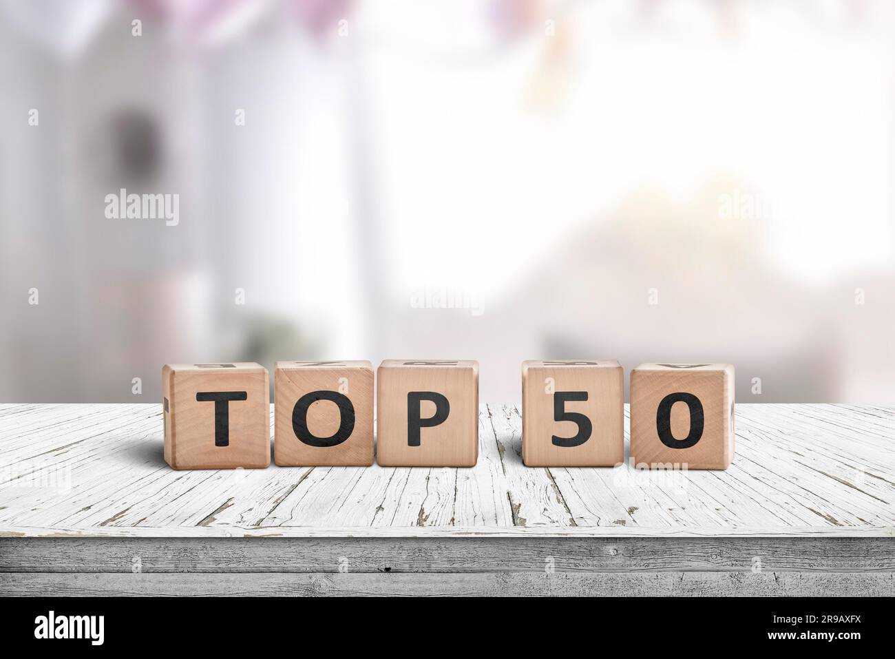 Top 50 sign made of wooden cubes on a desk i a bright living space ...