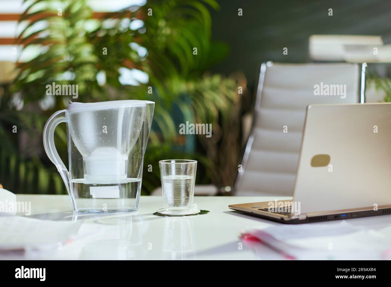 water filter and cup on the table in the modern office. Stock Photo