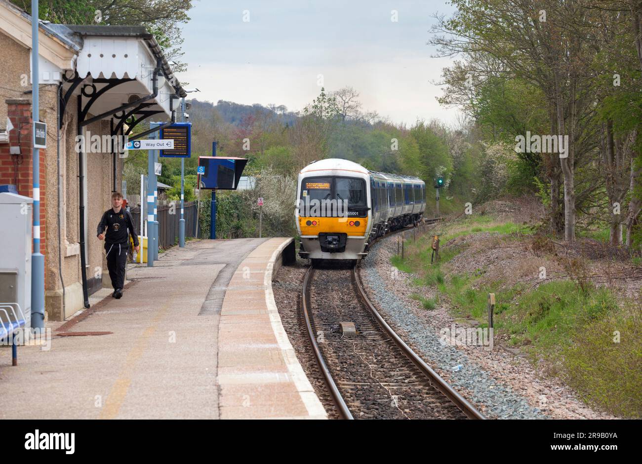 Little Kimble railway station with its single platform with a Chiltern Railways class 165  train departing with a single passenger Stock Photo