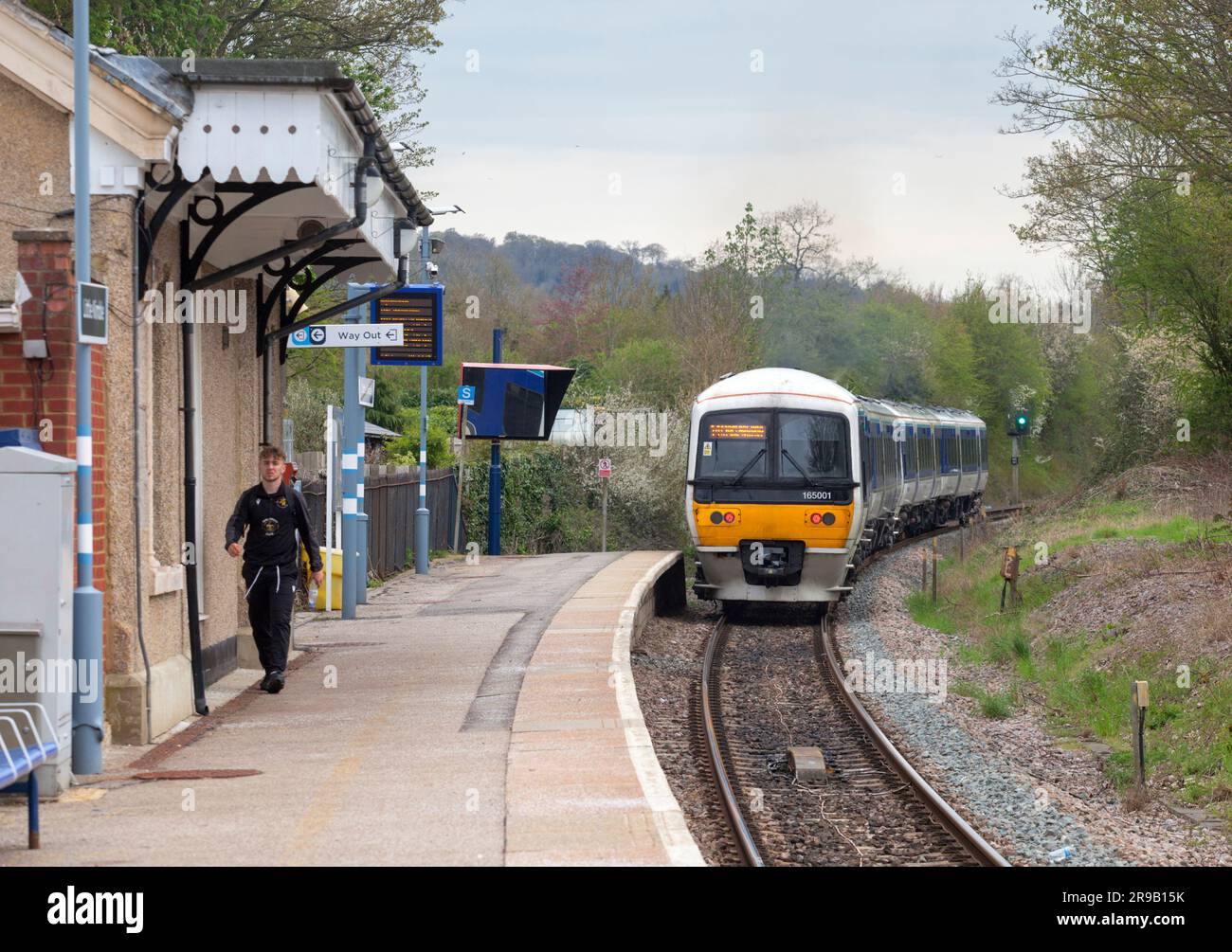 Little Kimble railway station with its single platform with a Chiltern Railways class 165  train departing with a single passenger Stock Photo