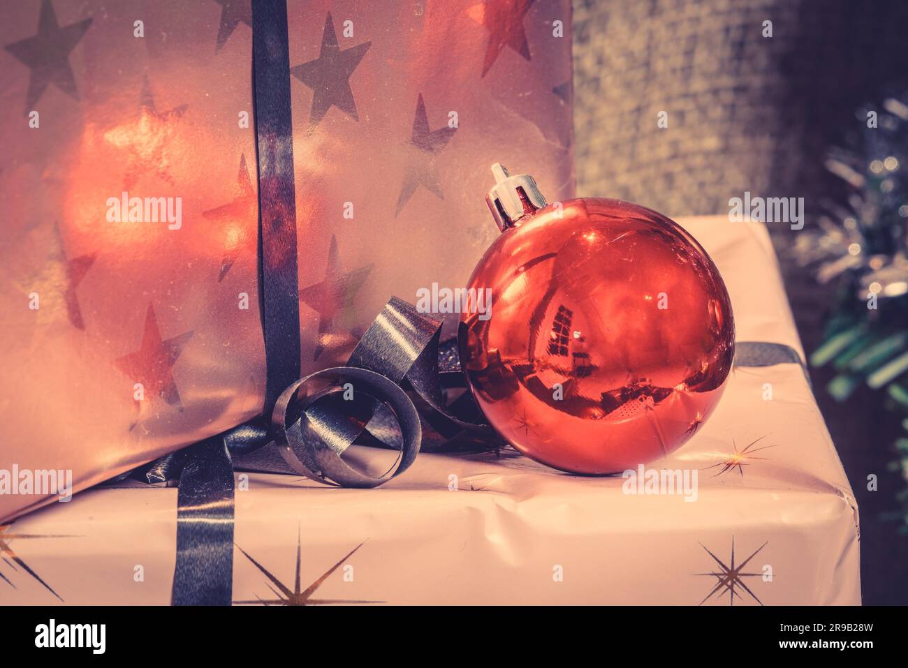 Christmas presents with a shiny red baubel Stock Photo