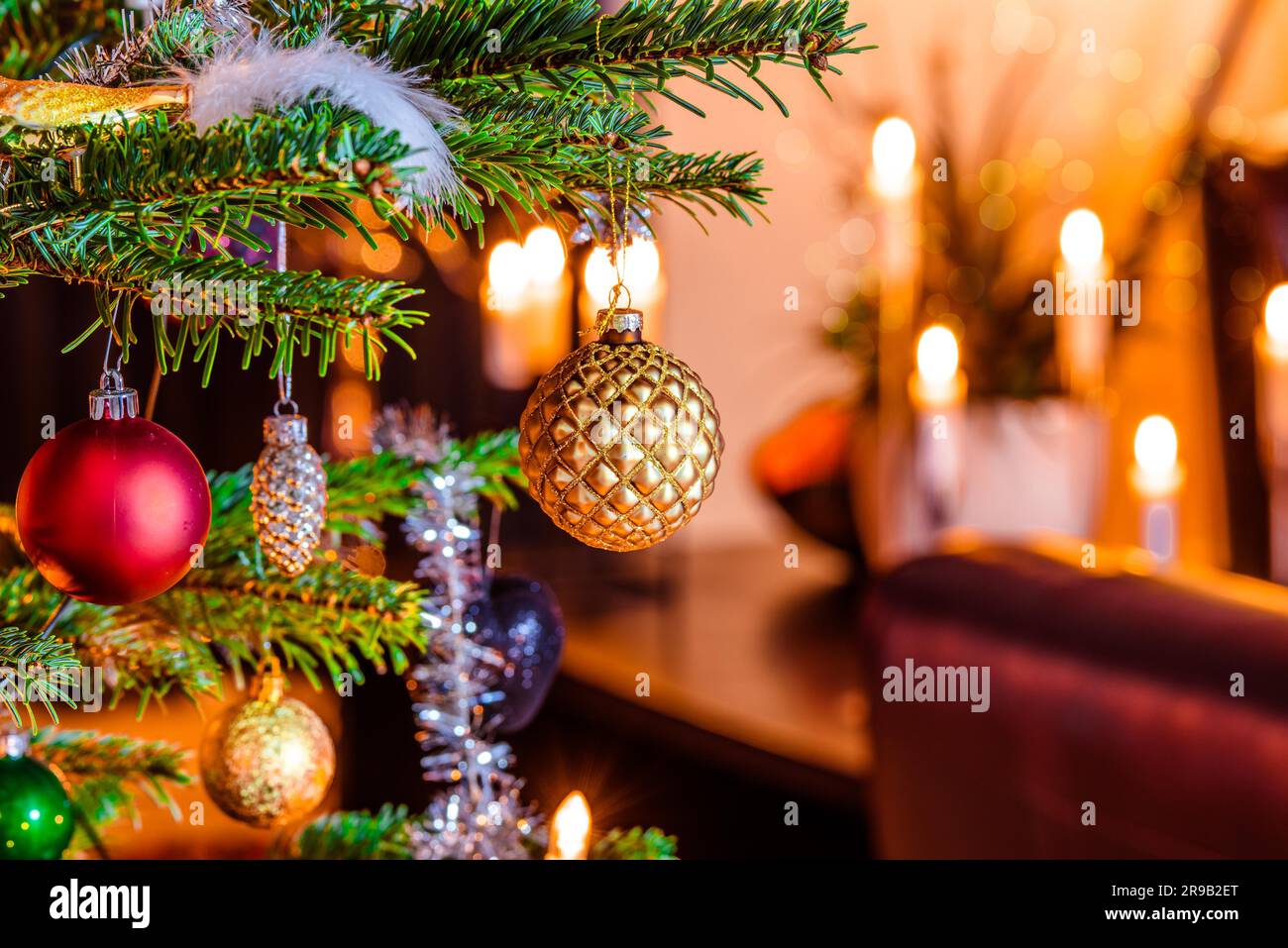 Christmas tree with shiny baubles in a living room Stock Photo