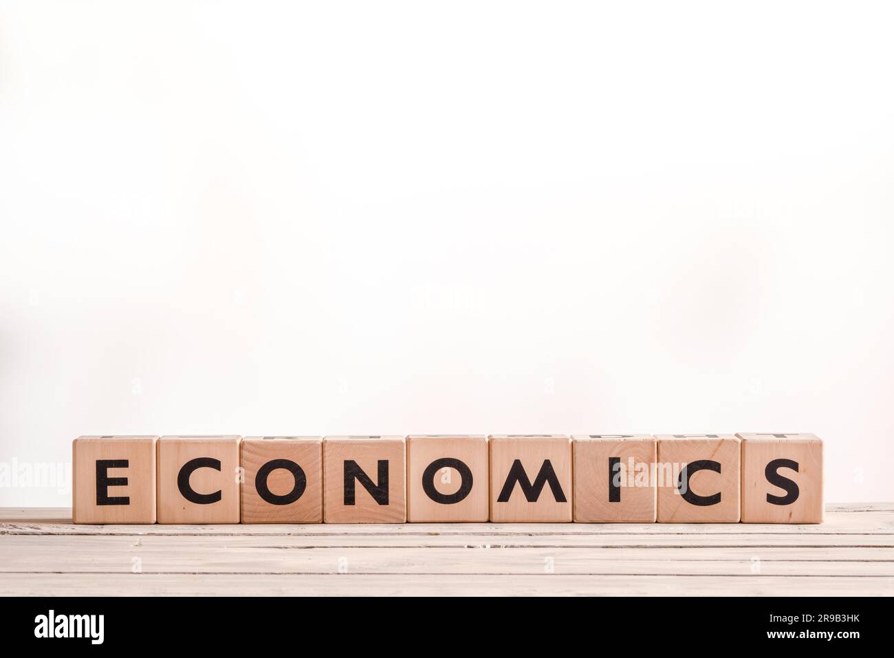 Economics sign made of blocks on a desk Stock Photo Alamy