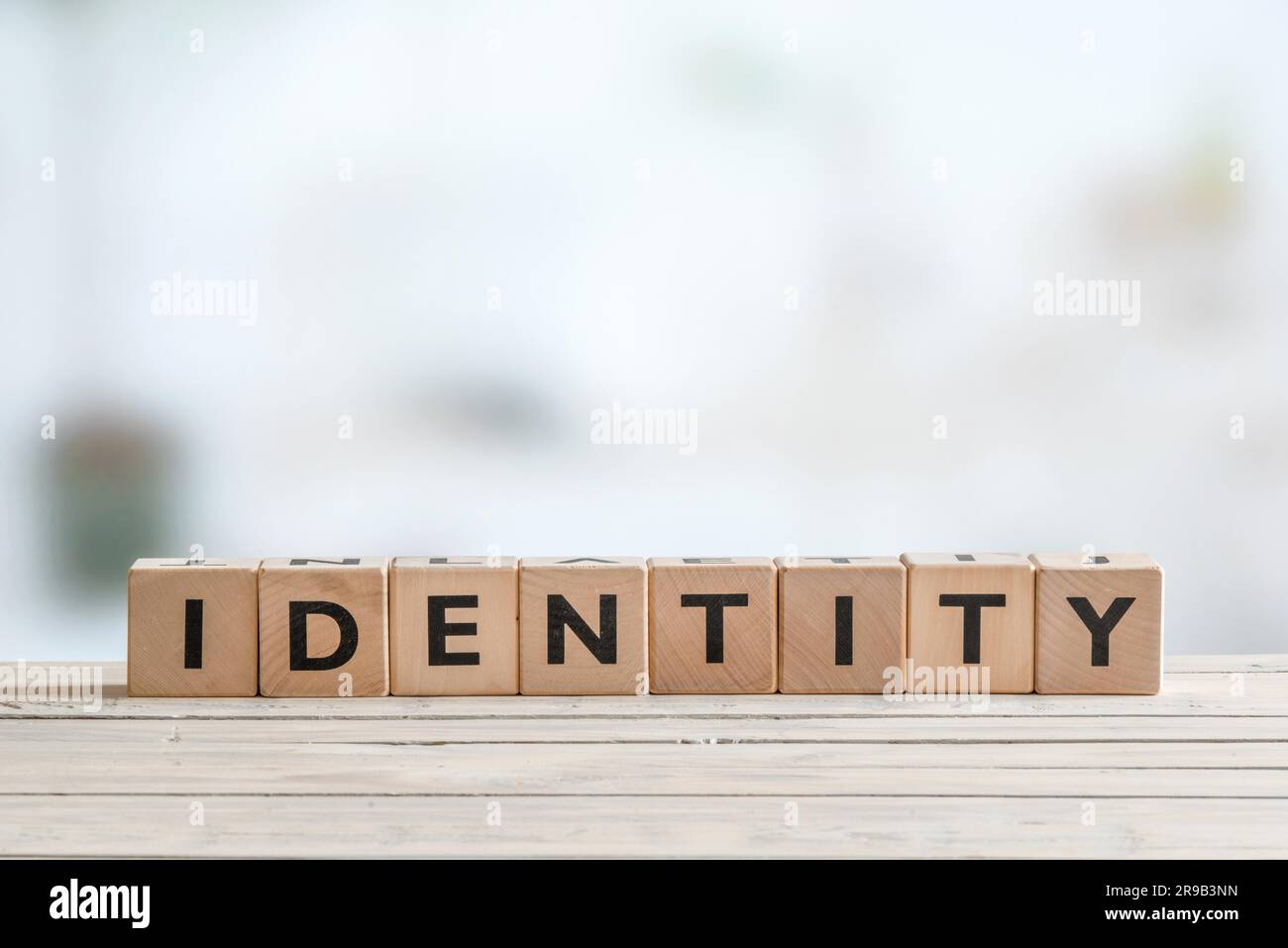 Identity sign made of cubes on wooden table Stock Photo