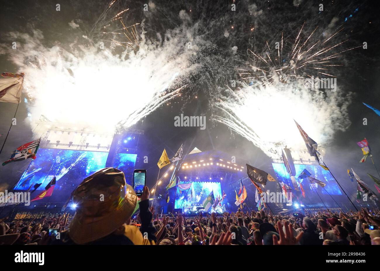 Editorial use only fireworks light up the sky as elton john performs on