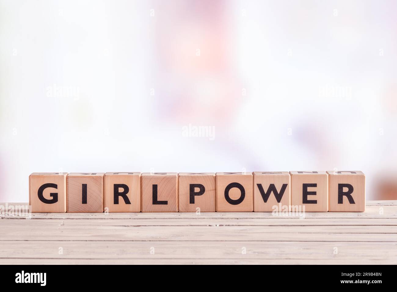Girlpower sign made of cubes on a table Stock Photo