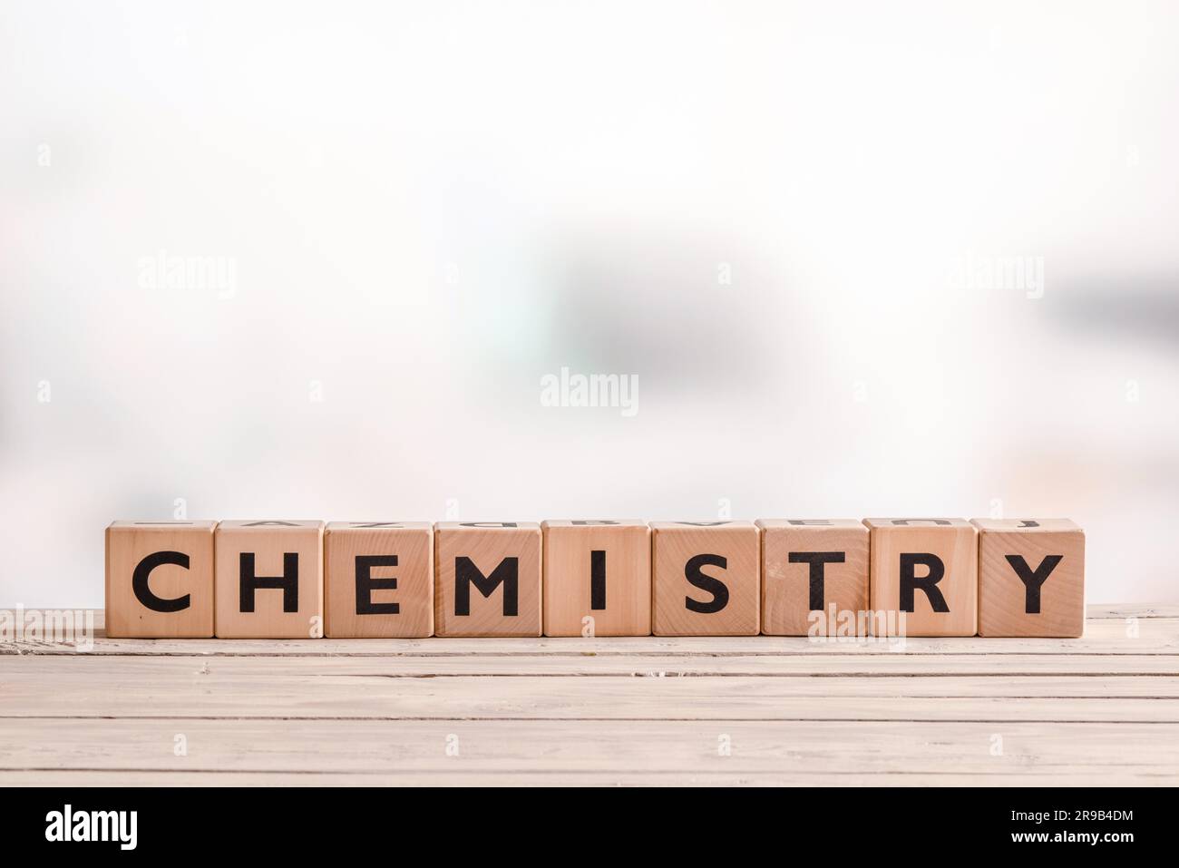 Chemistry sign on a wooden table in a room Stock Photo