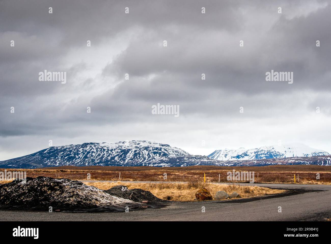 Cloudy weather by a road in dramatic landscape Stock Photo