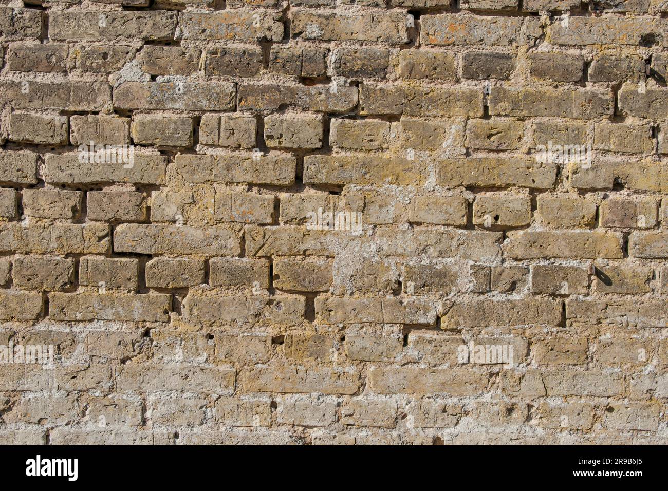 Brick wall with old stones and weathered material Stock Photo - Alamy