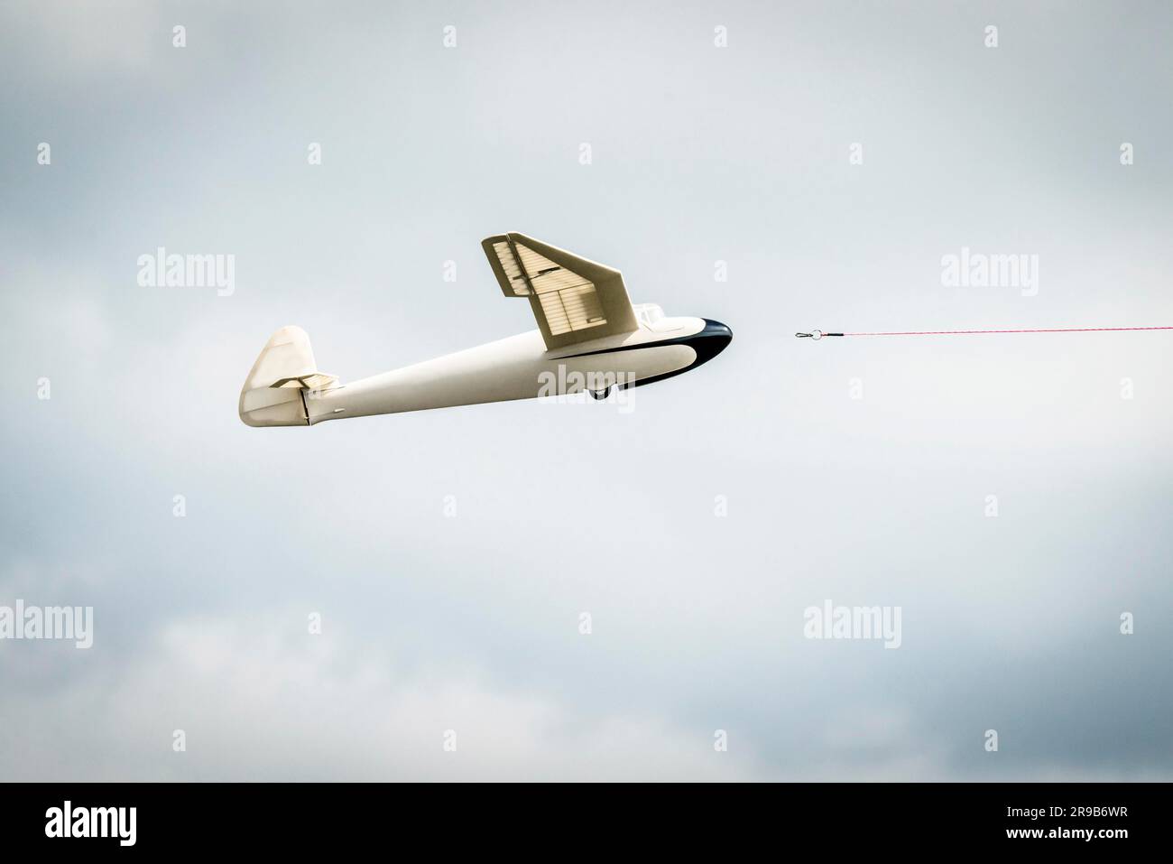 Small glider airplane with a line dragged into the air Stock Photo Alamy