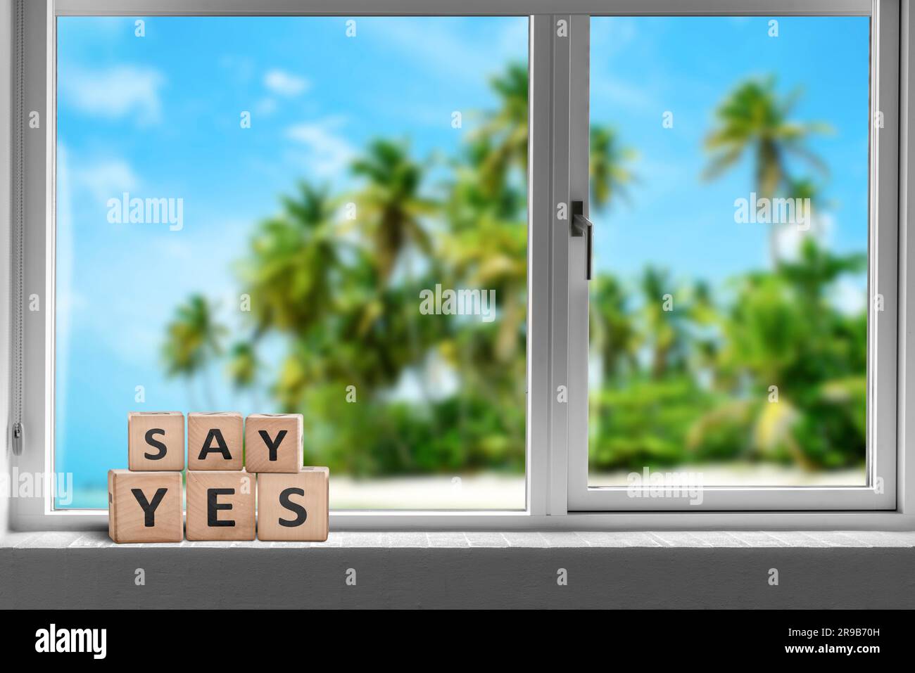 Say yes sign in a window on a tropical beach with palm trees in the