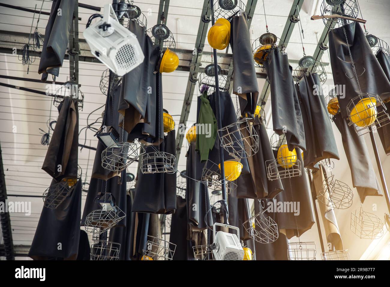 Scenic bottom view old abandoned coal mine worker clothing dressing room hanged at ceiling with chain lockers. Historical industrial mining museum Stock Photo