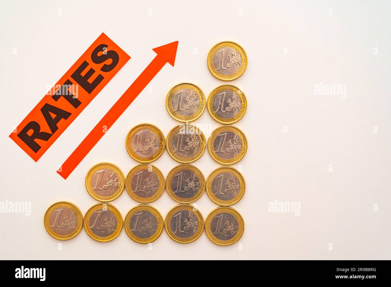 Rows of coins of increasing height, word rates, and red arrow pointing ...