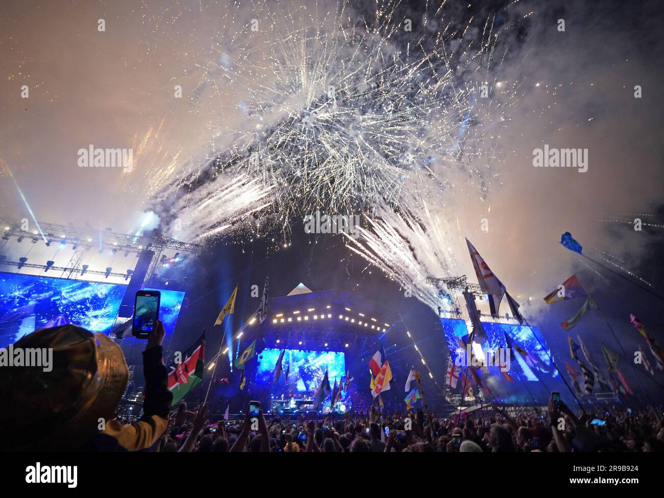 Editorial use only fireworks light up the sky as elton john performs on