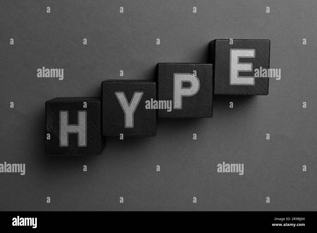 Word Hype of black cubes with letters on grey background, top view ...