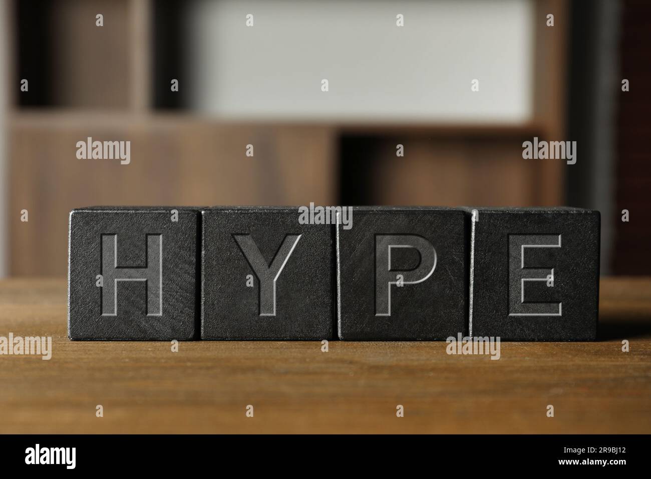 Word Hype of black cubes with letters on wooden table Stock Photo - Alamy
