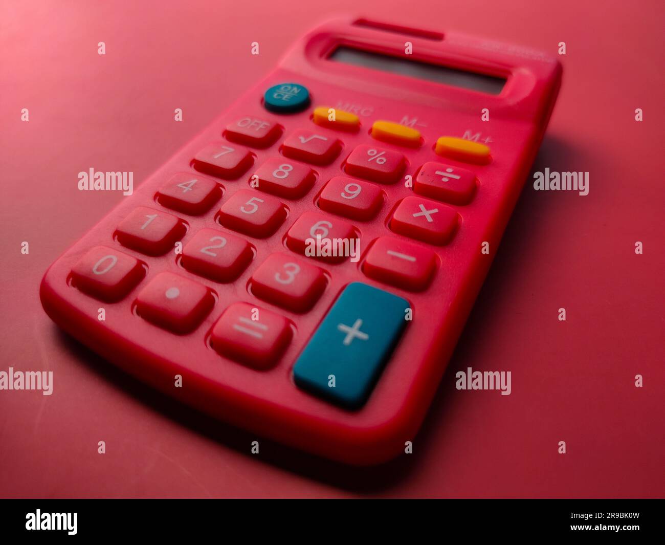 Closeup red calculator on a red background Stock Photo