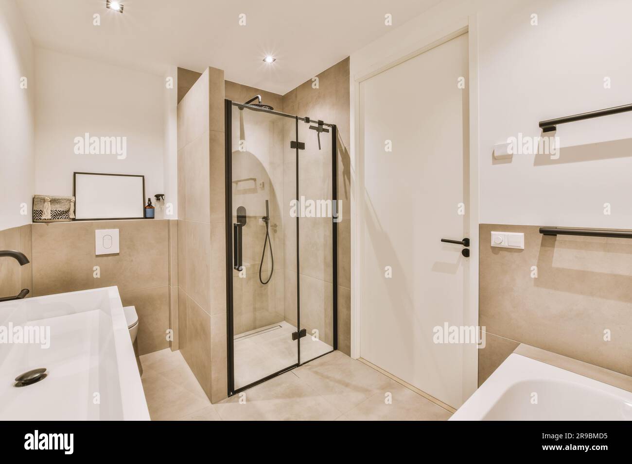 a modern bathroom with white walls and beige flooring, along with a ...