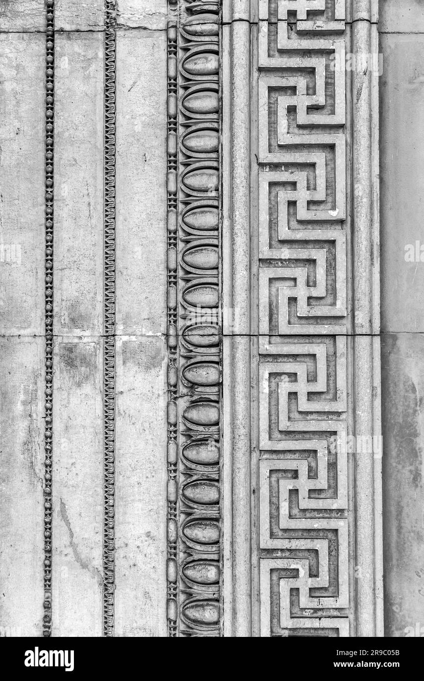 Detail from a wall with ancient Greek style bas relief carvings on