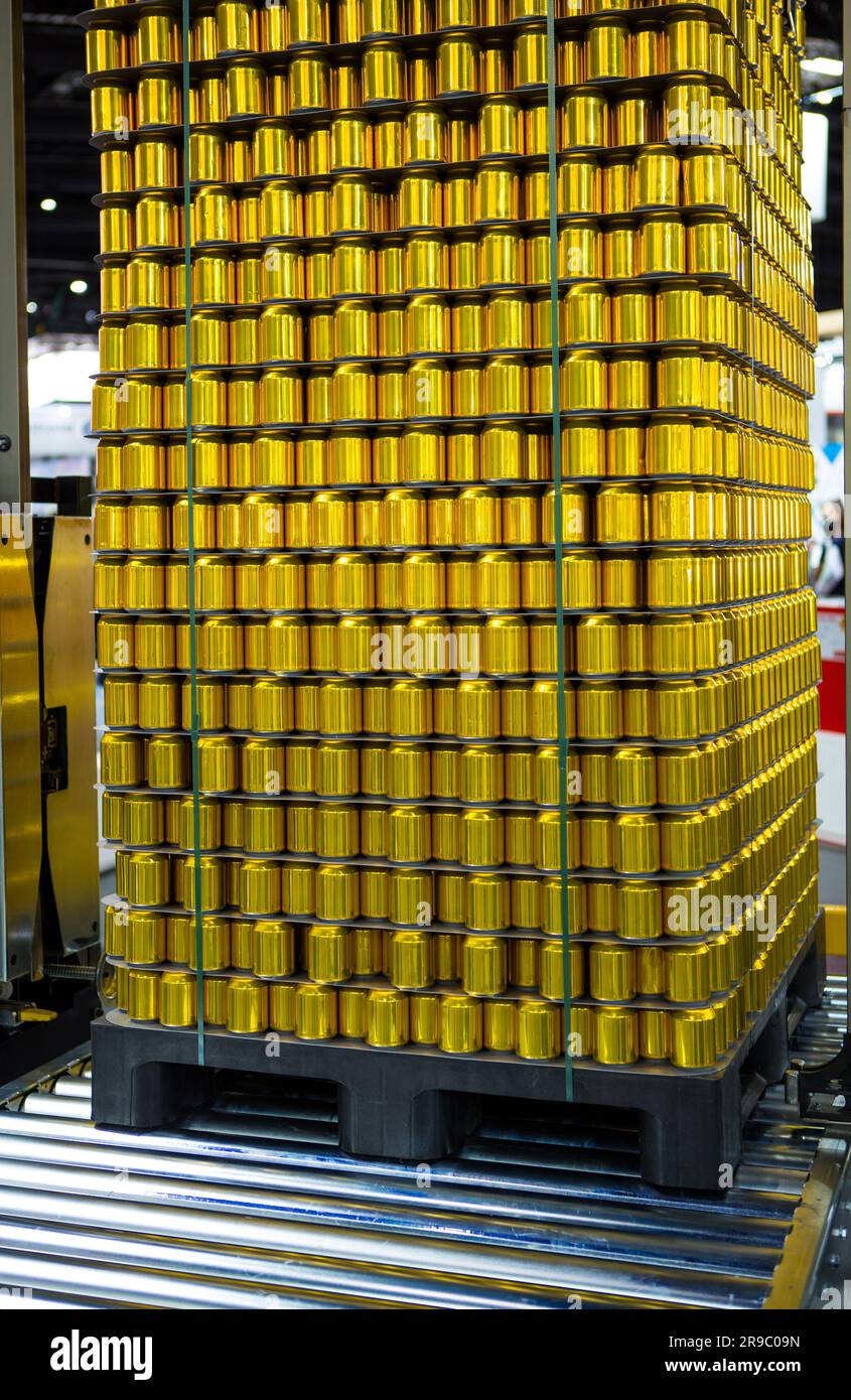 Golden canned food stacking on plastic pallet. Food industry Stock