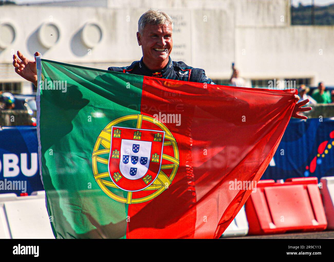 Lisbon, Portugal. 25th June, 2023. Former Formula One car driver David Coulthard with a flag at a Red Bull Showrun in Lisbon. Credit: SOPA Images Limited/Alamy Live News Stock Photo