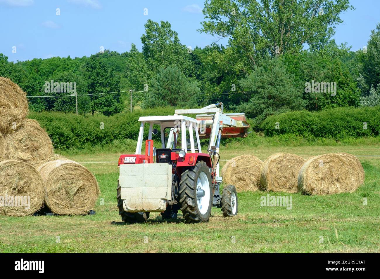 steyr 650 tractor being used to stack round hay bales after harvesting zala county hungary Stock Photo
