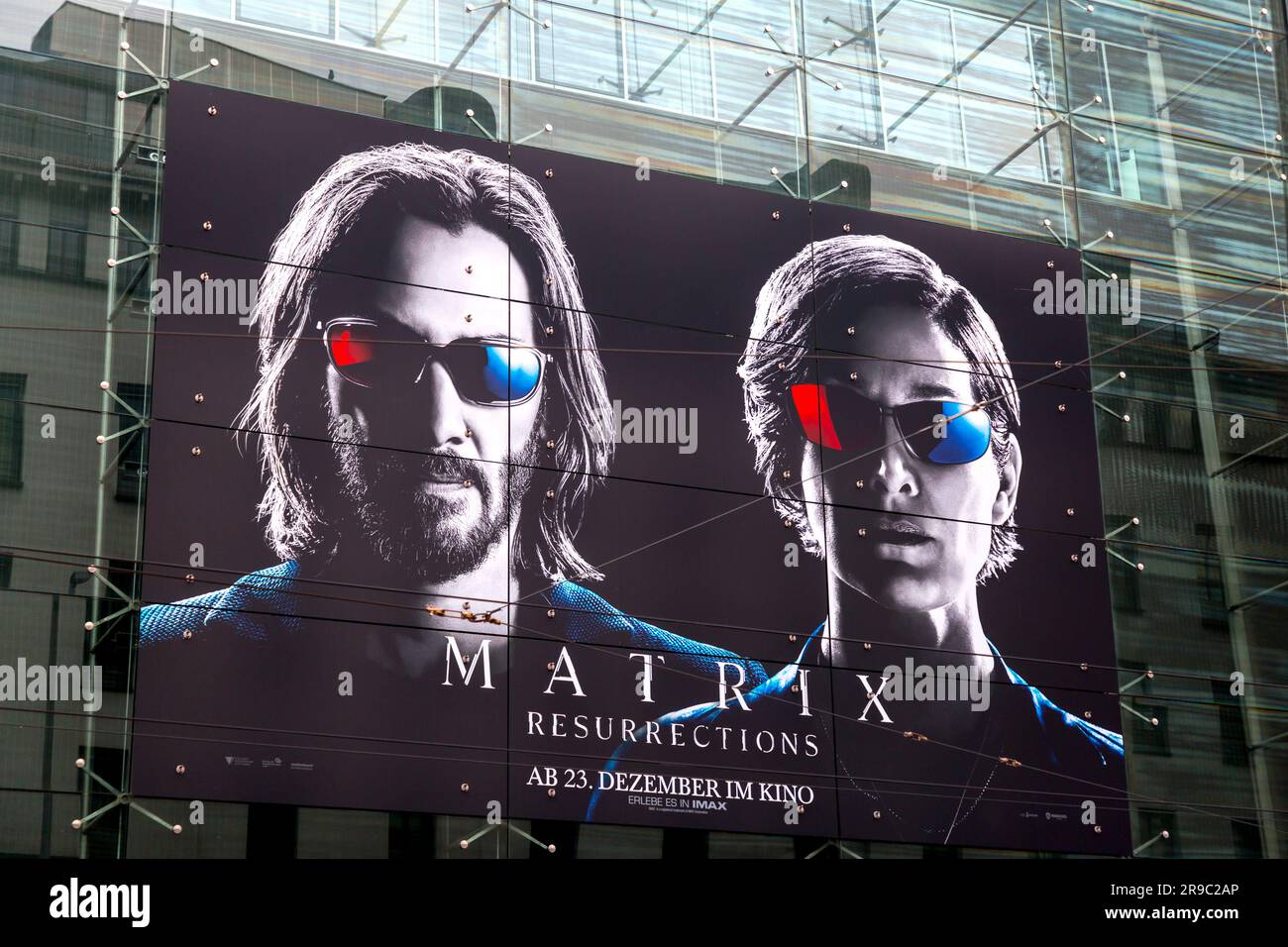 Munich, Germany - DEC 23, 2021: Large advertisement of the movie Matrix, Resurrections on the wall of a building on Bayerstrasse, Munich, Germany. Stock Photo
