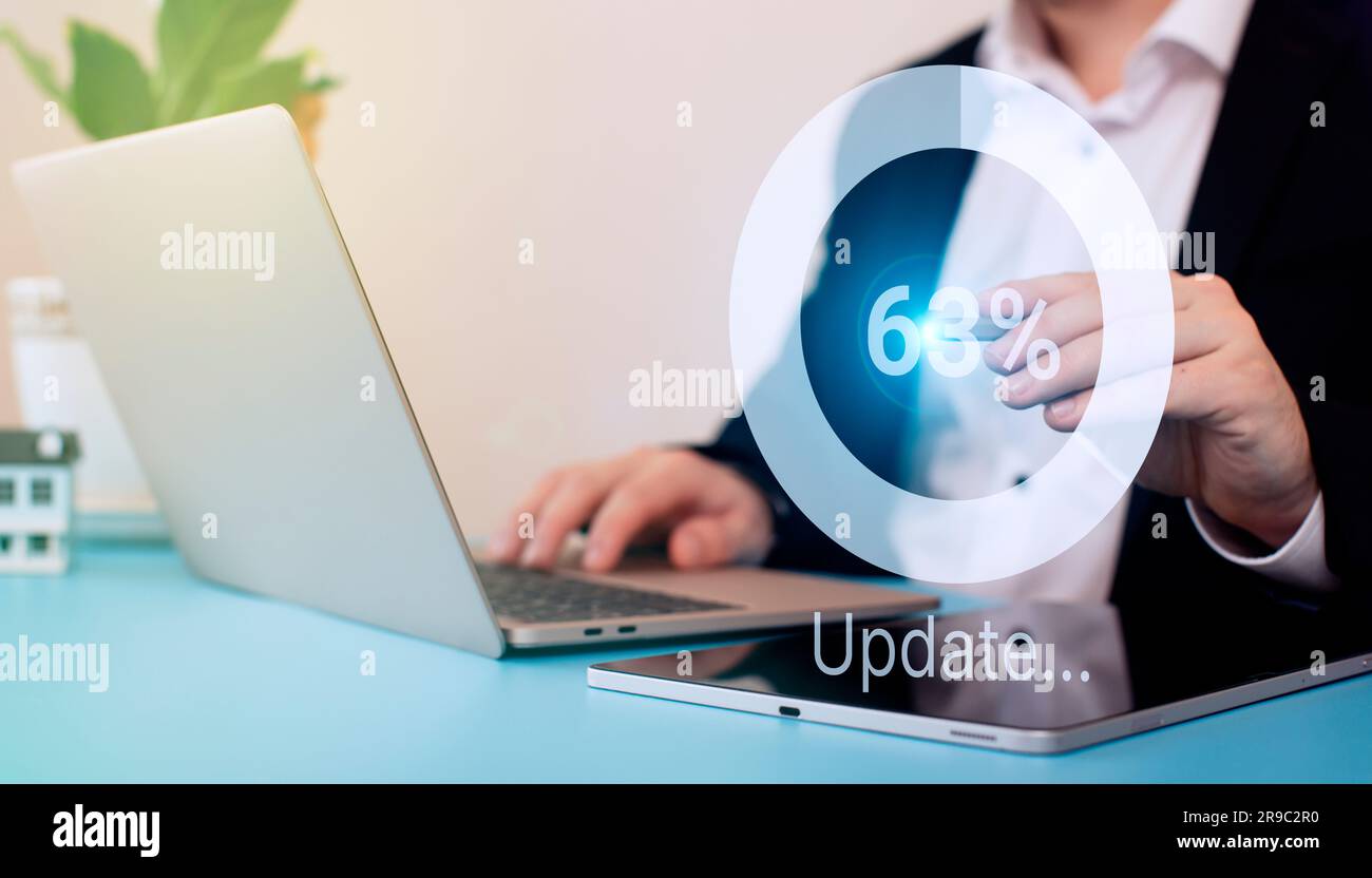Man using laptop at the table. update the operating system to a newer one. Systems engineer Stock Photo