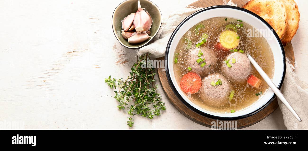 Knodel soup bowl and bread on light background. Panorama, banner Stock Photo