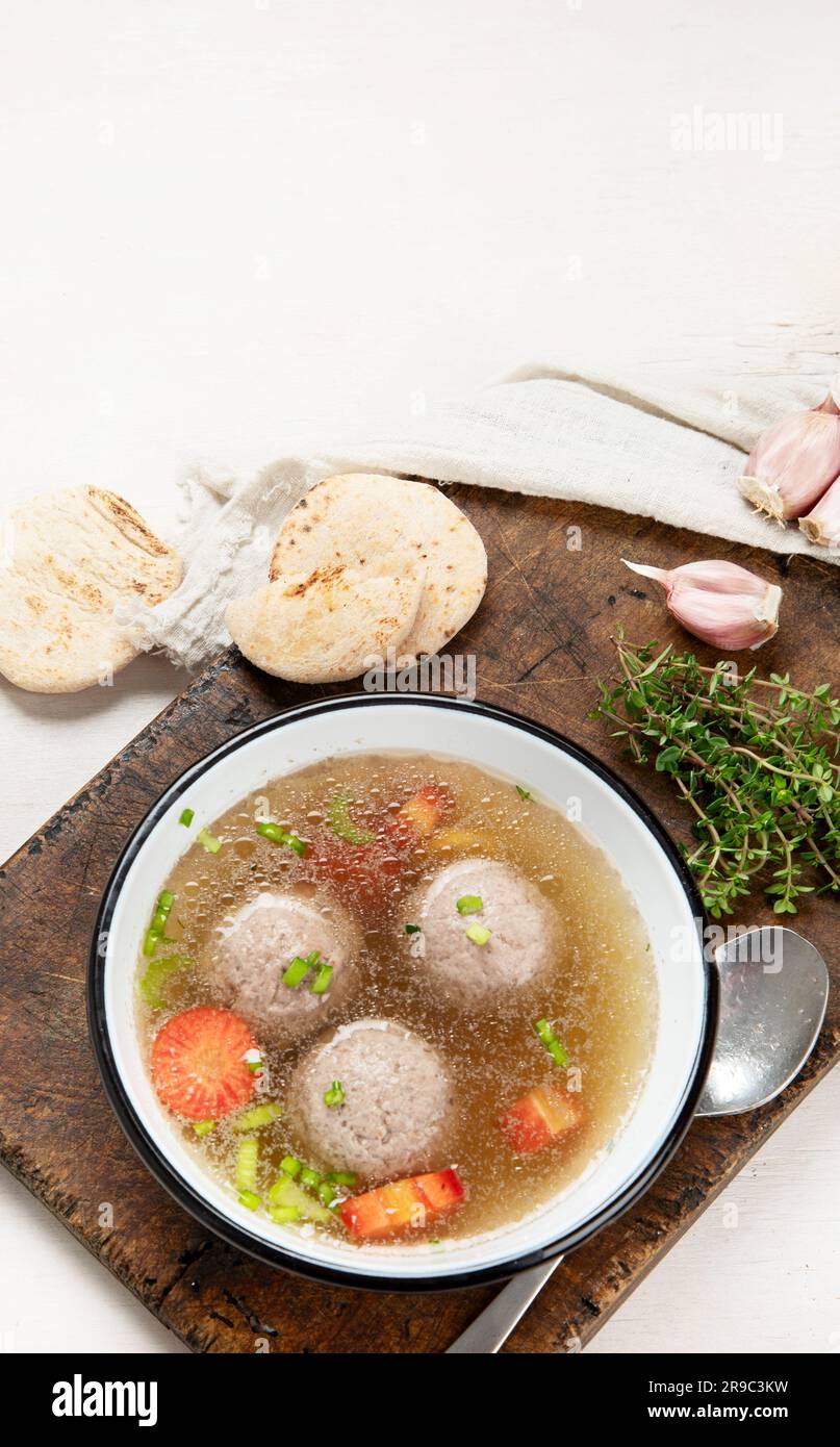 Knodel soup bowl and bread on light backround Stock Photo