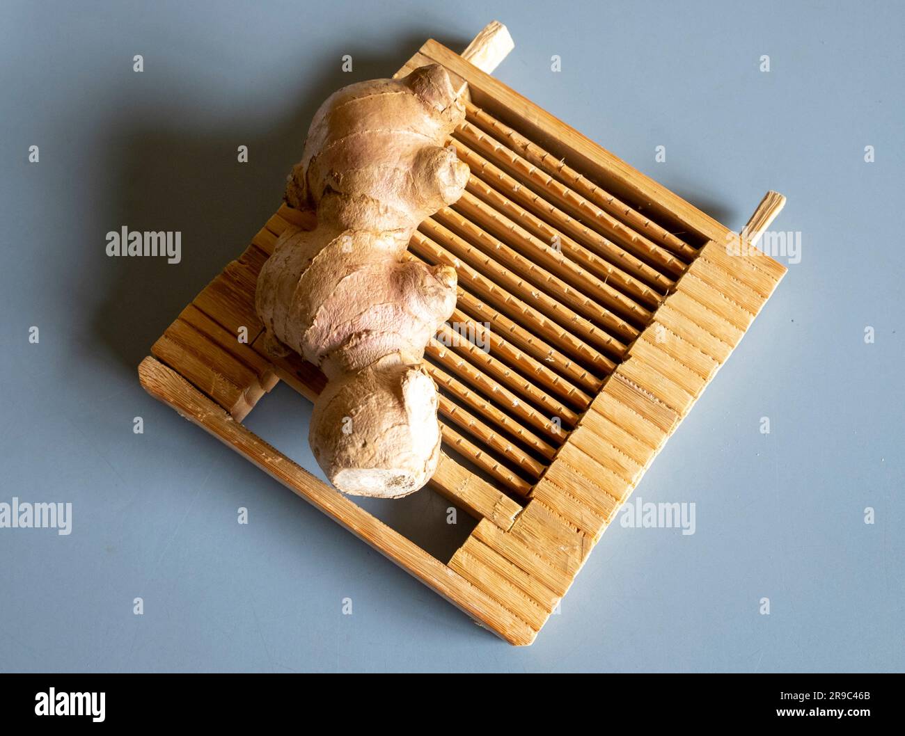 A traditional handmade Asian bamboo ginger grater with ginger Stock