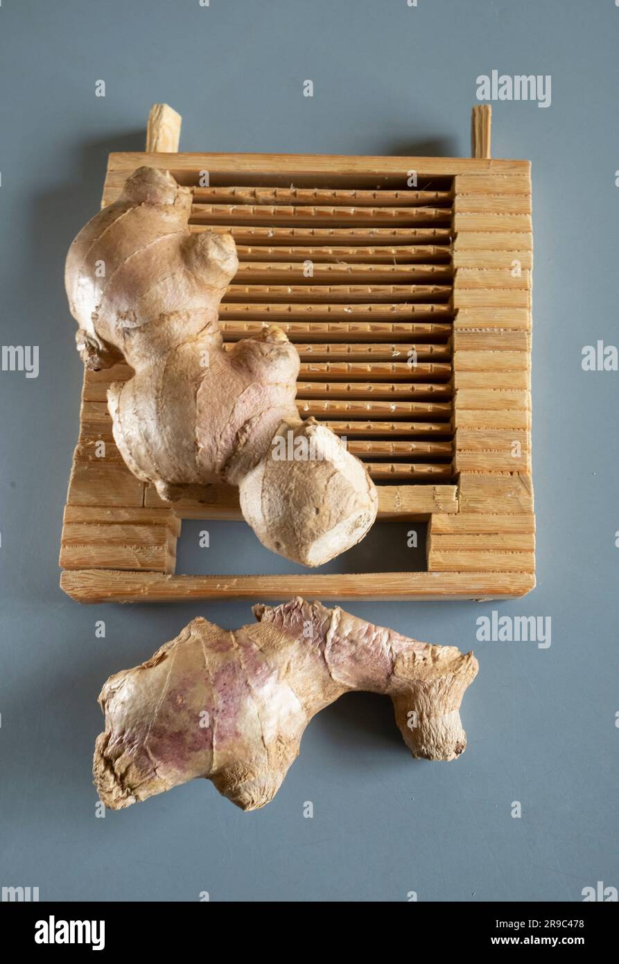 A traditional handmade Asian bamboo ginger grater with ginger Stock