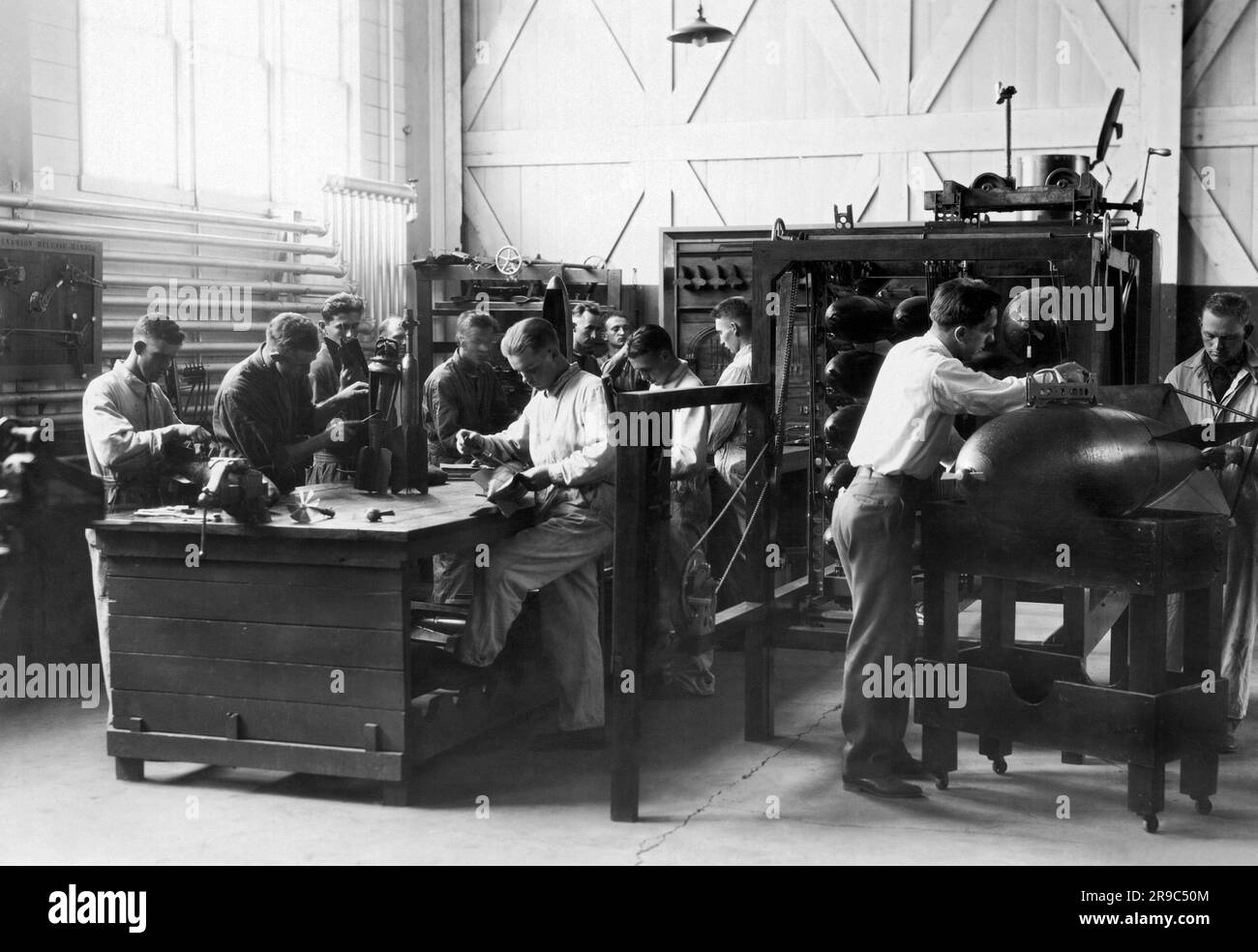 Chanute Field, Illinois:  c.  1919 Students studying the intricacies of aircraft bombs at the Air Corp Technical School. Stock Photo