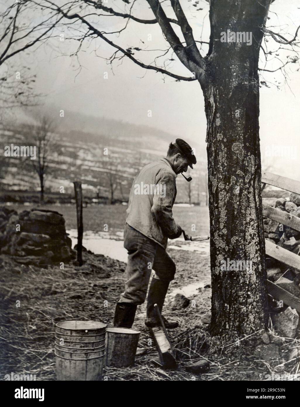 United States c. 1930 A man using a brace and bit to drill into a