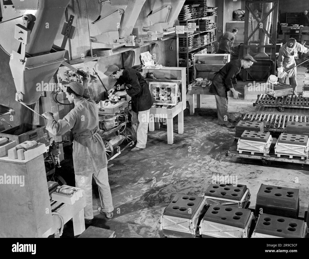 Los Angeles, California:  c. 1955 Workers in the precision casting foundry section at the AiResearch Manufacturing Company. Stock Photo