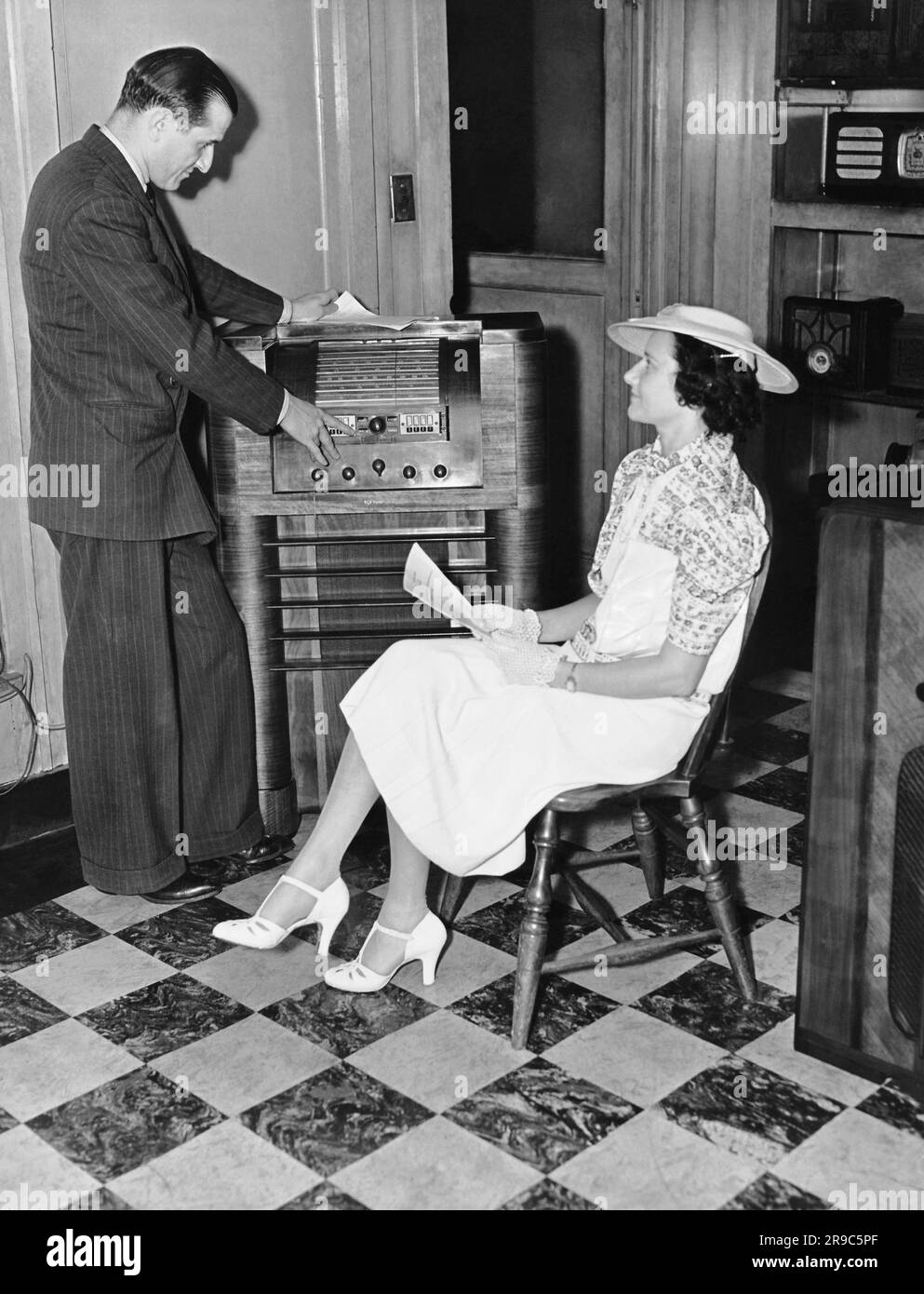 United States c. 1937 A radio salesman shows the latest models to a
