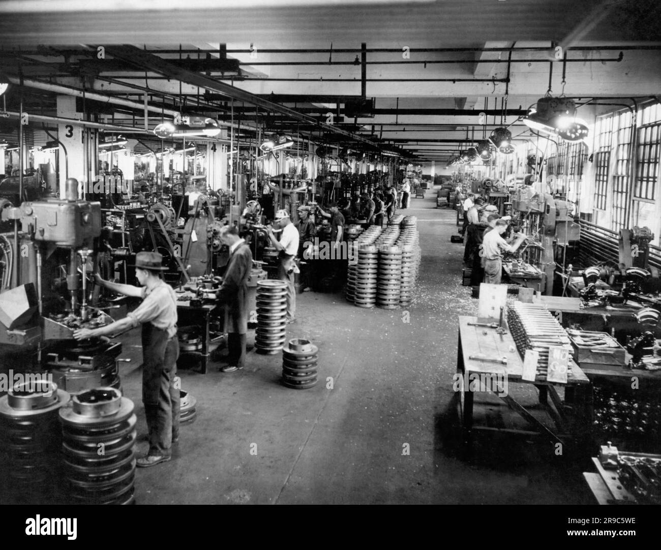 Unites States:  c. 1929 Workers machining metal parts in a factory. Stock Photo